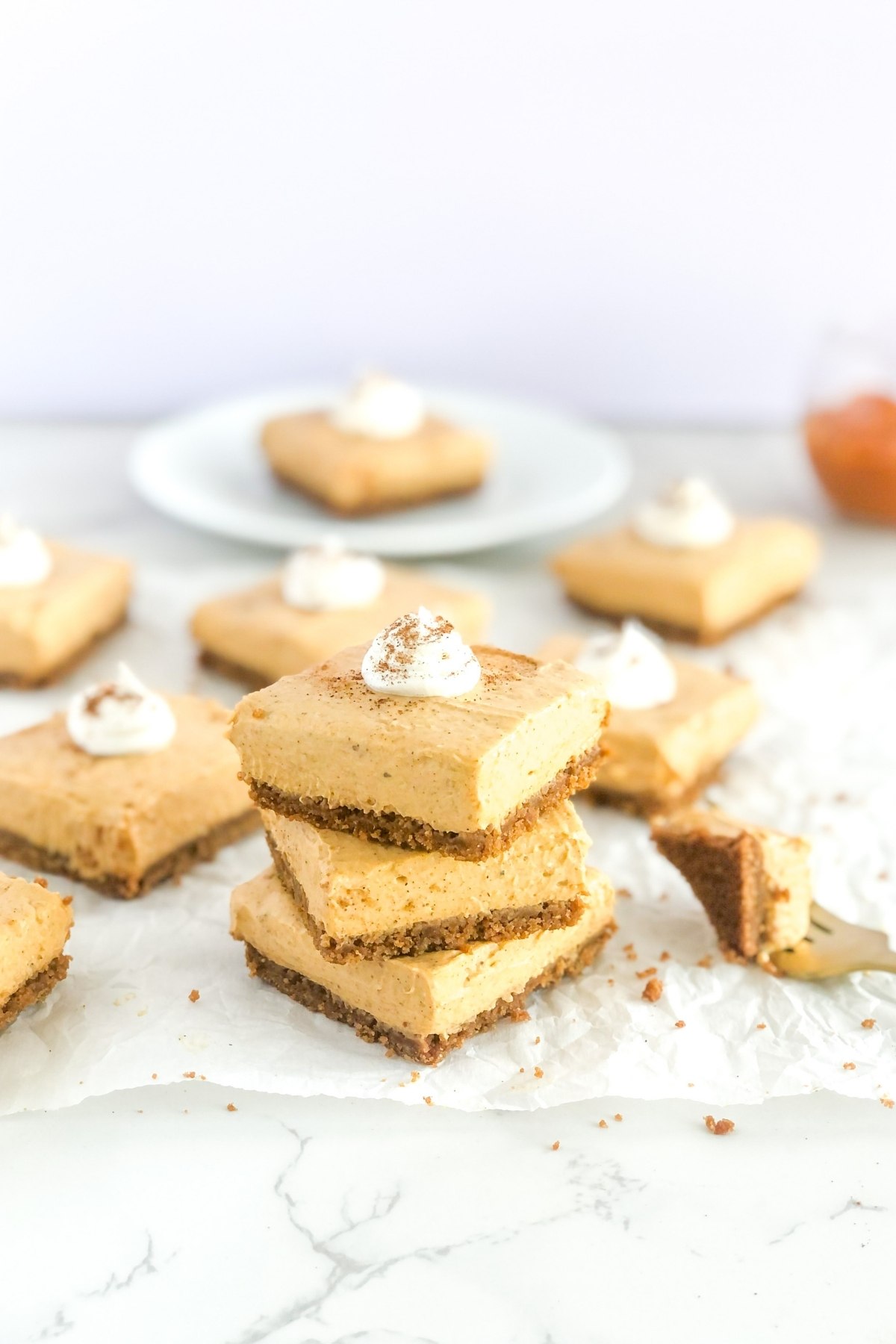 stack of no bake pumpkin cheesecake bars with Biscoff cookie crust