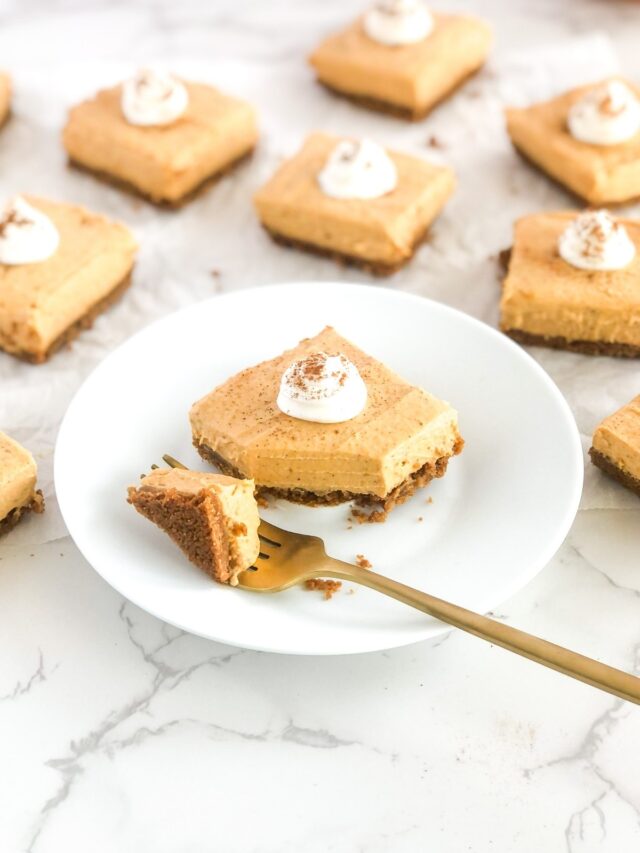 gold fork cutting into no bake pumpkin cheesecake on a white plate