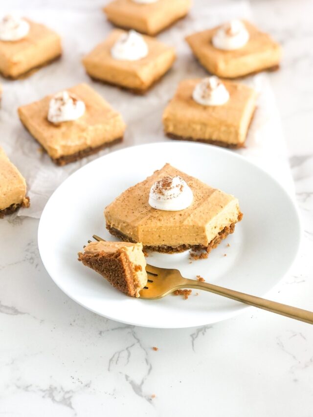 gold fork cutting into no bake pumpkin cheesecake on a white plate