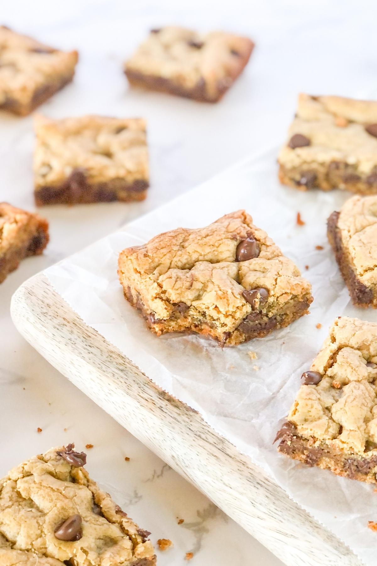 chocolate chip peanut butter cookie bars on parchment paper