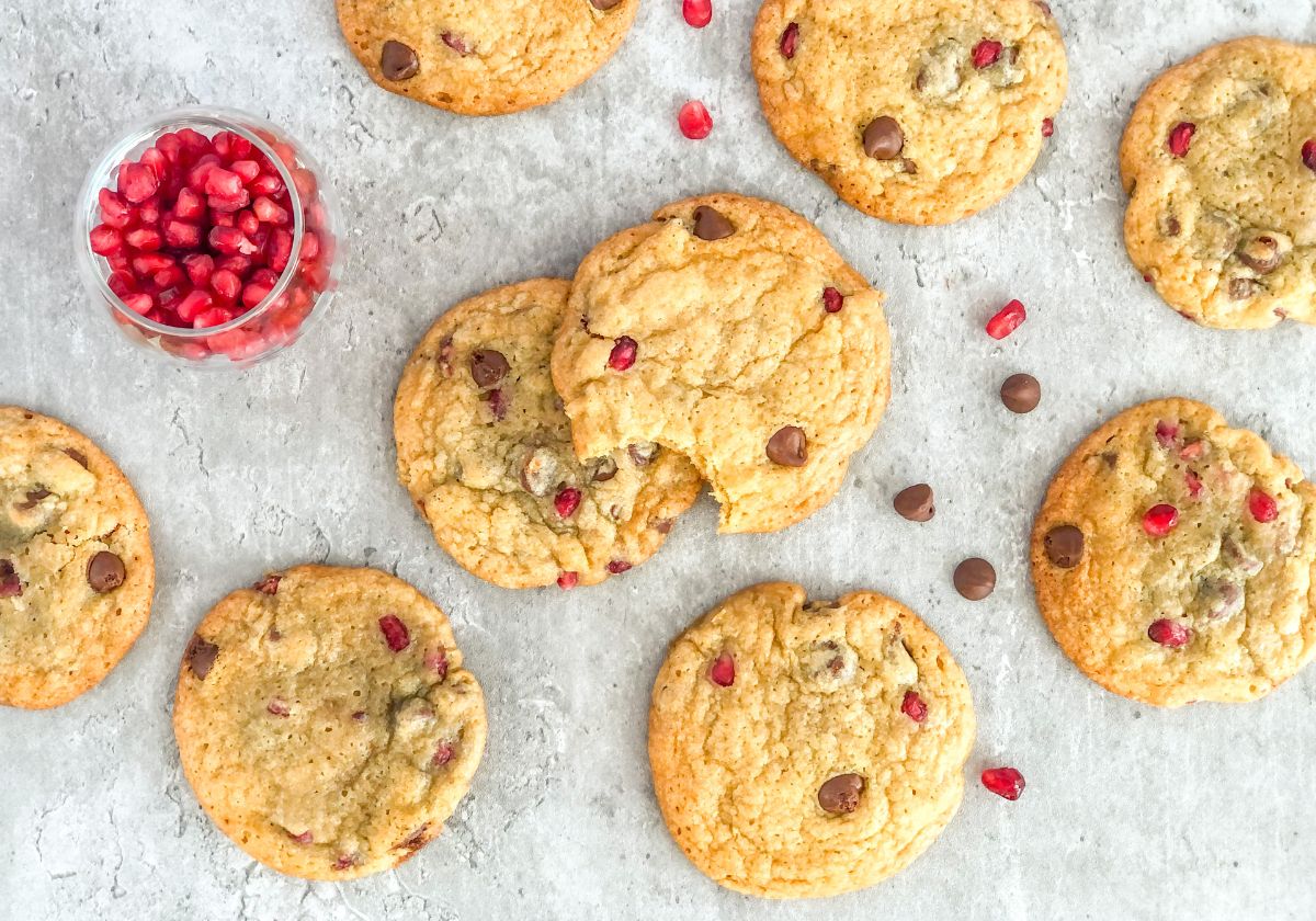 chocolate chip pomegranate cookies with a small jar of pomegranate seeds
