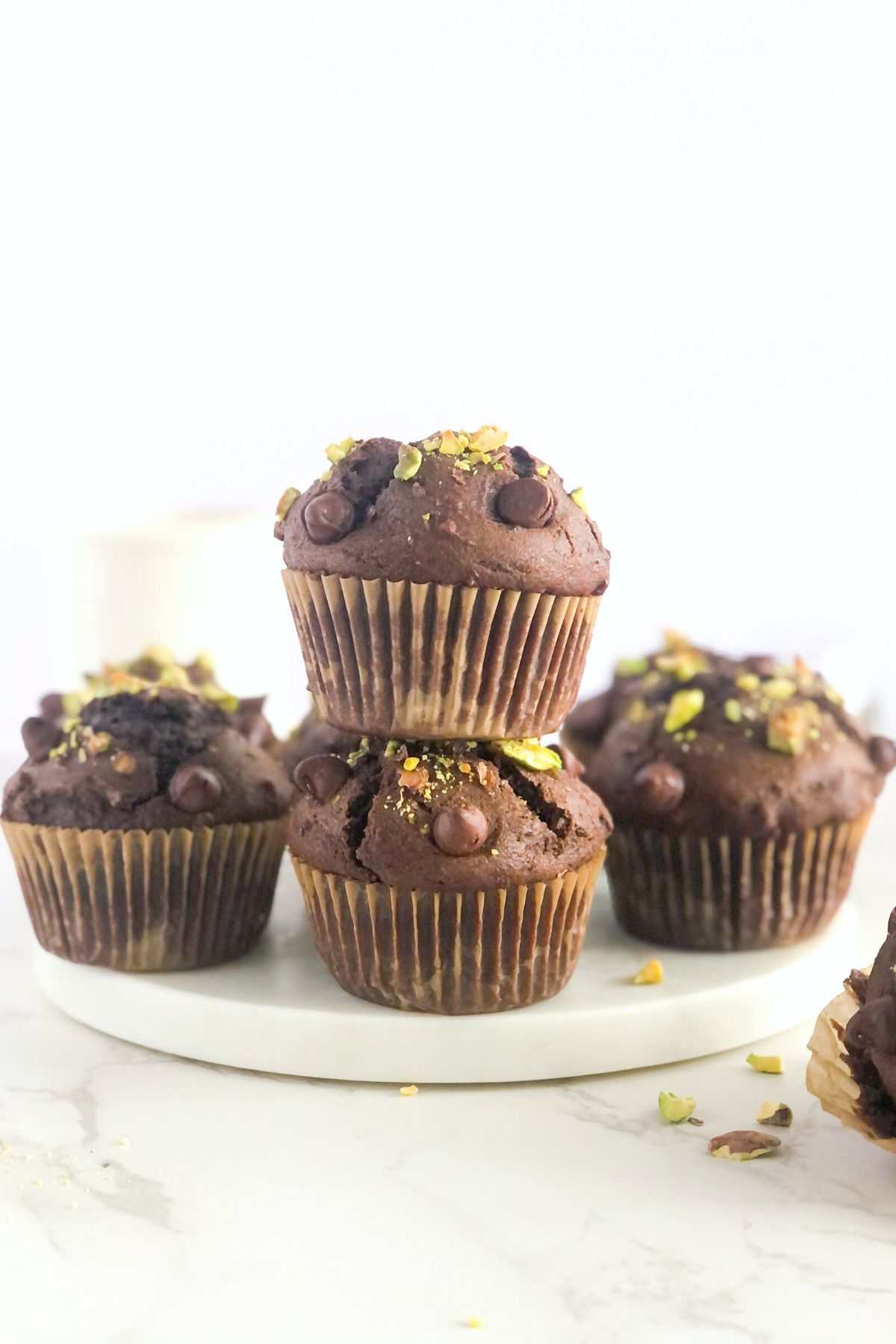 stack of double chocolate muffins with pistachios