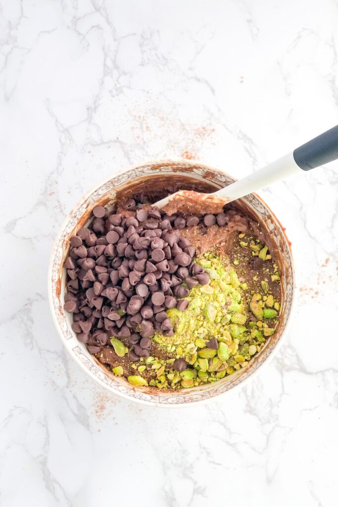 chocolate muffin batter with chocolate chips and pistachios