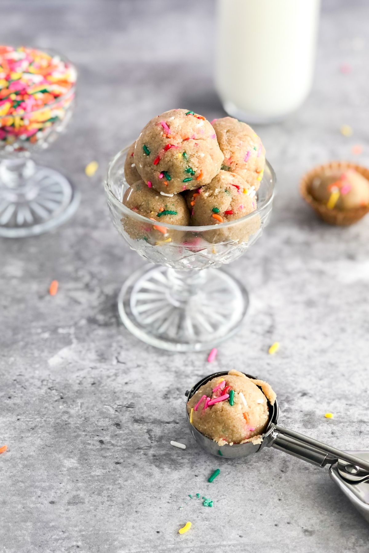 gluten free sugar cookie dough with sprinkles in a cookie scoop