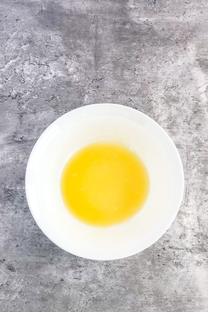 melted butter and white sugar in a bowl