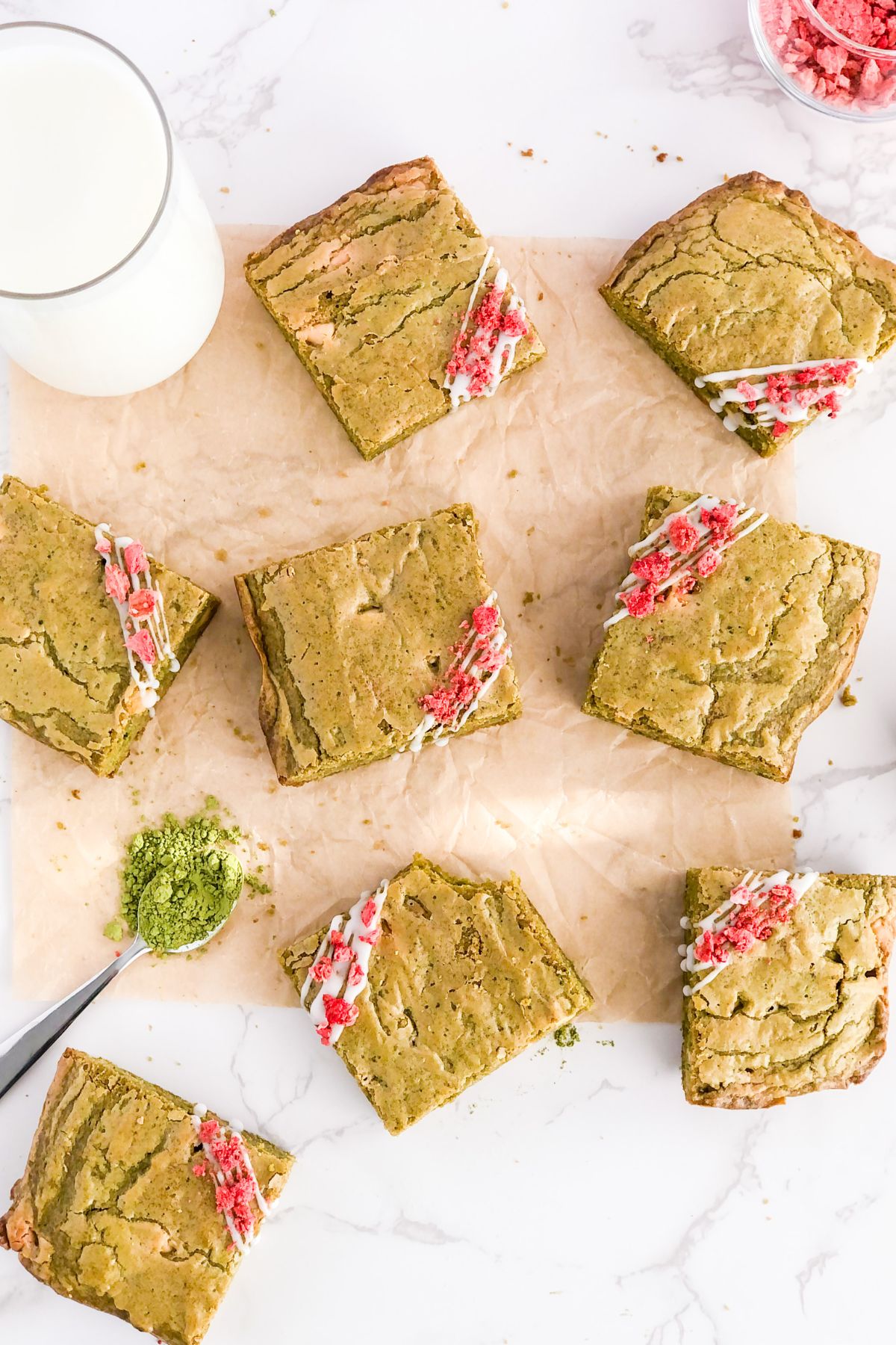 matcha brownies with icing drizzle on parchment paper