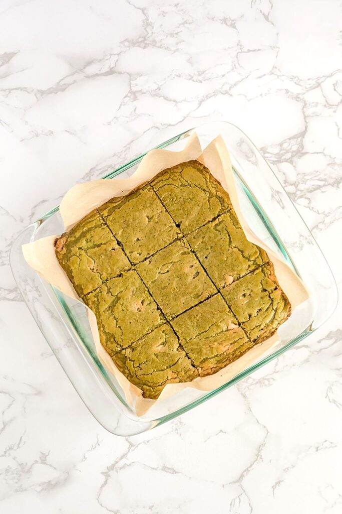 baked white chocolate matcha brownies in a glass pan