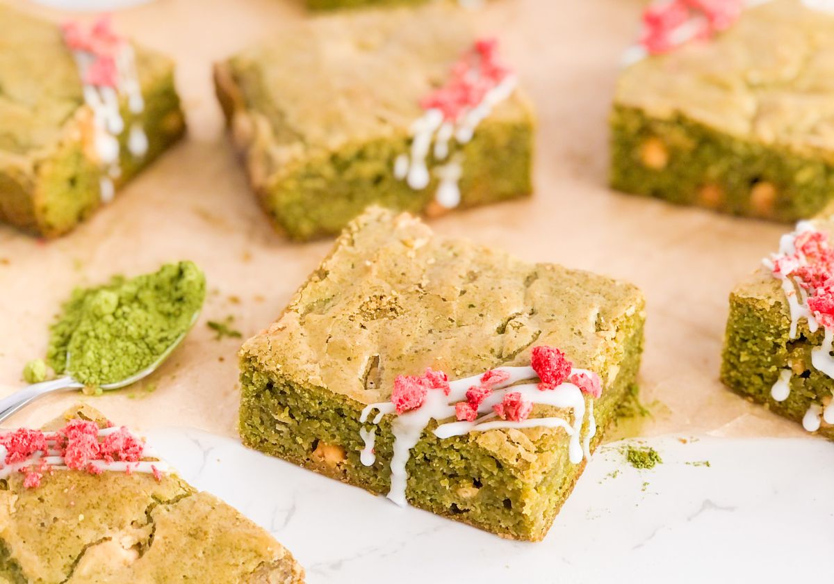 matcha brownies with icing drizzle and crushed dried strawberries on top